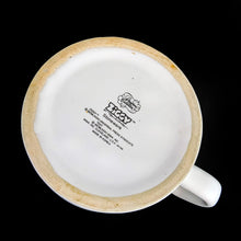 Load image into Gallery viewer, Vintage Designers Collection Ziggy comic stoneware mug. This heavy stoneware mug is white with a red stripe around the rim along with Ziggy and his colourful group of furry friends with the phrase "Soups On“ in a cartoon speech bubble. The perfect mug for your favourite cup of soup! Designed by cartoonist Tom Wilson for Universal Press Syndicate. Made in Korea, 1982. In excellent condition, free from chips/cracks/wear. Appears to not have been used. Measures 4 x 2-7/8 inches Capacity 12 ounces