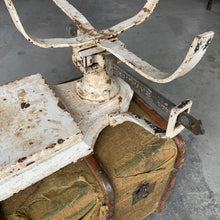 Load image into Gallery viewer, Vintage cast iron platform scale with wicker basket. Crafted by W.T. Avery Ltd., Birmingham, England, 1930s. The paint is chippy perfection and the basket is in great condition considering its age. This would have been used in a grocers, or as a baby scale. Would look amazing in any shabby chic or farmhouse decor filled with fruits, breads or a lovely dried floral arrangement. A one-of-a-kind display piece!
In as found vintage condition.
Measures 25 x 47 inches