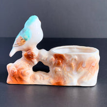 Load image into Gallery viewer, Vintage hand painted planter featuring an aqua and amber perched on a branch. Crafted in Japan, 1950s. A sweet decor piece for a small succulent, to hold toothpicks or matches.
In excellent condition, no chips. Marked Hand Painted Japan 1950s.
Measures 5 x 1 3/4 x 3 1/2 inches