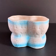 Load image into Gallery viewer, Vintage white baby booties planter with blue bows and edge details, plus a little green and yellow. This adorable planter would look lovely filled with your favourite plant or succulent or use it to store and display baby accessories. Sticker on the bottom 'Parma by AAI Taiwan'. Excellent condition, no chips or cracks. Size: 4" x 4" x 3"