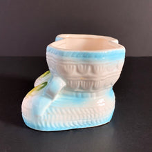 Load image into Gallery viewer, Vintage white baby booties planter with blue bows and edge details, plus a little green and yellow. This adorable planter would look lovely filled with your favourite plant or succulent or use it to store and display baby accessories. Sticker on the bottom 'Parma by AAI Taiwan'. Excellent condition, no chips or cracks. Size: 4" x 4" x 3"
