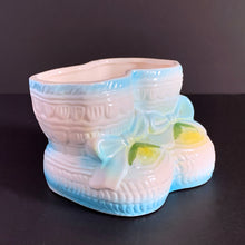 Load image into Gallery viewer, Vintage white baby booties planter with blue bows and edge details, plus a little green and yellow. This adorable planter would look lovely filled with your favourite plant or succulent or use it to store and display baby accessories. Sticker on the bottom 'Parma by AAI Taiwan'. Excellent condition, no chips or cracks. Size: 4" x 4" x 3"