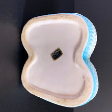 Load image into Gallery viewer, Vintage white baby booties planter with blue bows and edge details, plus a little green and yellow. This adorable planter would look lovely filled with your favourite plant or succulent or use it to store and display baby accessories. Sticker on the bottom 'Parma by AAI Taiwan'. Excellent condition, no chips or cracks. Size: 4" x 4" x 3"