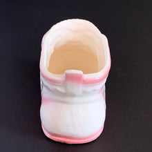 Load image into Gallery viewer, Vintage white ceramic baby bootie planter with blue bows and pink details. Crafted by Rubens Originals, Japan, 1950s. A perfect addition to nursery decor to hold a plant or baby accessories!
Excellent condition, no chips or cracks. Marked on the bottom.
Measures 4 x 2 1/4 x 2 1/2 inches