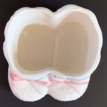 Load image into Gallery viewer, Vintage white baby booties ceramic planter features pink bows, white and blue flowers. Crafted by Nancy Pew Giftware, Taiwan, 1970s. An adorable accessory for a baby nursery!
In excellent condition, no chips, cracks or repairs. Maker's mark and sticker.
Measures 4 x 4 x 3 inches