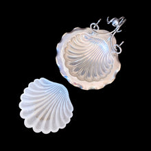 Load image into Gallery viewer, Antique shell-shaped silver plated butter dish with satin glass insert, bun feet and its raised scrolled rest is meant to hold a butter knife. What a special decorative dish to add a hint of elegance to your dining table.
Impressed hallmark EPNS ENGLAND the number 5 and an indiscernible curved mark, circa 1912.
In as found condition, no chips on the glass insert.
Measures 5 1/2 x 6 x 4 1/2 inches