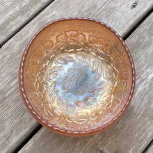 Load image into Gallery viewer, This vintage Two Flowers marigold carnival glass bowl features an intricate design of dogwood flowers and marsh lilies, a smooth sawtooth rim and three spatulate feet. Crafted by Fenton Art Glass, early 20th century. The iridescence on this bowl is outstanding and it's sure to become a treasured heirloom. In excellent condition, no chips. Measures 6 1/4 x 3 1/2 inches