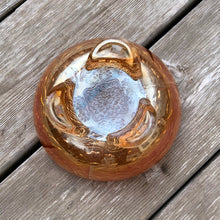 Load image into Gallery viewer, This vintage Two Flowers marigold carnival glass bowl features an intricate design of dogwood flowers and marsh lilies, a smooth sawtooth rim and three spatulate feet. Crafted by Fenton Art Glass, early 20th century. The iridescence on this bowl is outstanding and it's sure to become a treasured heirloom. In excellent condition, no chips. Measures 6 1/4 x 3 1/2 inches