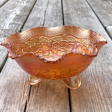 Load image into Gallery viewer, Lovely vintage "Two Flowers" iridescent marigold carnival glass bowl featuring Dogwood and Marsh Lily flowers with fluted edge on three spatulate feet. Crafted by Fenton Art Glass, USA, circa 1920s. A sweet piece for any Fenton collector! In excellent condition, free from chips. Measures 7 5/8 x 3 3/4 inches