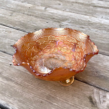 Load image into Gallery viewer, Lovely vintage "Two Flowers" iridescent marigold carnival glass bowl featuring Dogwood and Marsh Lily flowers with fluted edge on three spatulate feet. Crafted by Fenton Art Glass, USA, circa 1920s. A sweet piece for any Fenton collector! In excellent condition, free from chips. Measures 7 5/8 x 3 3/4 inches