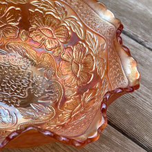 Load image into Gallery viewer, Lovely vintage "Two Flowers" iridescent marigold carnival glass bowl featuring Dogwood and Marsh Lily flowers with fluted edge on three spatulate feet. Crafted by Fenton Art Glass, USA, circa 1920s. A sweet piece for any Fenton collector! In excellent condition, free from chips. Measures 7 5/8 x 3 3/4 inches
