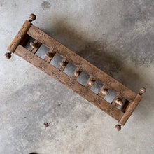Load image into Gallery viewer, Lovingly handcrafted one-of-a-kind vintage wood wall-hung coat rack, featuring hand carved florals, the phrase "du-te dorule si spune la mandruta vorbe bune", loosely translated mean "they long for good words" and turned pegs. A true piece of old world craftsmanship to enhance your entryway, mudroom, bedroom or bath.
In as found vintage condition, missing one peg.
Measures 36 x 13 x 8 1/2 inches
