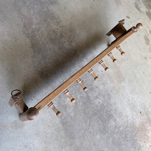 Load image into Gallery viewer, Lovingly handcrafted one-of-a-kind vintage wood wall-hung coat rack, featuring hand carved florals, the phrase "du-te dorule si spune la mandruta vorbe bune", loosely translated mean "they long for good words" and turned pegs. A true piece of old world craftsmanship to enhance your entryway, mudroom, bedroom or bath.
In as found vintage condition, missing one peg.
Measures 36 x 13 x 8 1/2 inches