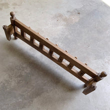 Load image into Gallery viewer, Lovingly handcrafted one-of-a-kind vintage wood wall-hung coat rack, featuring hand carved florals, the phrase "du-te dorule si spune la mandruta vorbe bune", loosely translated mean "they long for good words" and turned pegs. A true piece of old world craftsmanship to enhance your entryway, mudroom, bedroom or bath.
In as found vintage condition, missing one peg.
Measures 36 x 13 x 8 1/2 inches