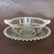 Load image into Gallery viewer, Vintage Imperial Candlewick cut Corn Flower glass open-handled mayonnaise bowl and underplate, with twelve-petalled flowers and leaf sprays. Imperial Glass Company blanks. Crafted by WJ Hughes, Canada, 1950s. Classic elegant tableware that is always in style!
In excellent condition, no chips. Normal age-related wear.
Plate measures 7 inches
Bowl measures 7 x 2 inches (incl. handles)