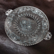 Load image into Gallery viewer, Stunning vintage cut Corn Flower glass serving plate on a Viking Glass blank, shape #4462, features a central set surrounded by six sets of corn flowers and leaf sprays with decorative handles. Crafted by WJ Hughes, Canada 1950s. An elegant serving piece for your favourite desserts. Makes a lovely hostess, wedding or housewarming gift!
In excellent condition, no chips.
Measures 13 inches