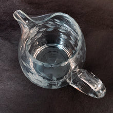 Load image into Gallery viewer, Vintage cut Corn Flower clear glass ice lip pitcher with 3 sets of 12-petalled corn flowers and leaf sprays, beaded rim with applied blown glass open handle. Crafted by WJ Hughes, Canada. An elegant piece for your table or bar service. Makes an excellent gift.
In excellent condition, no cracks.
Measures 6 inches