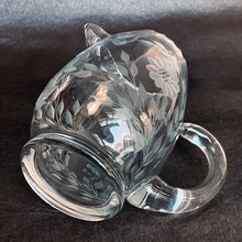 Load image into Gallery viewer, Vintage cut Corn Flower clear glass ice lip pitcher with 3 sets of 12-petalled corn flowers and leaf sprays, beaded rim with applied blown glass open handle. Crafted by WJ Hughes, Canada. An elegant piece for your table or bar service. Makes an excellent gift.
In excellent condition, no cracks.
Measures 6 inches