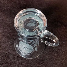 Load image into Gallery viewer, Vintage WJ Hughes cut "Corn Flower" pattern shot glass with two sets of twelve-petal and leaf sprays and applied blown glass open handle. The glass blank was produced by the West Virginia Glass Specialties. This locally cut shot glass is an important part of Toronto's rich history of fine mid-20th century craftsmanship. In excellent condition, free from chips or cracks. Measures 3-1/2"