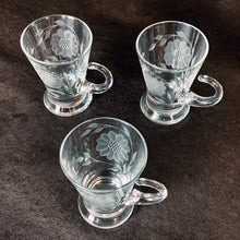 Load image into Gallery viewer, Vintage WJ Hughes cut "Corn Flower" pattern shot glass with two sets of twelve-petal and leaf sprays and applied blown glass open handle. The glass blank was produced by the West Virginia Glass Specialties. This locally cut shot glass is an important part of Toronto's rich history of fine mid-20th century craftsmanship. In excellent condition, free from chips or cracks. Measures 3-1/2"