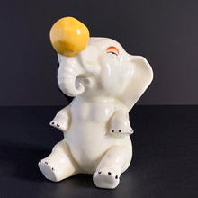 Load image into Gallery viewer, RARE FIND!!!
Adorable art deco white circus elephant balancing yellow ball porcelain figurine. Crafted by Crown Devon, England, 1920s/30s. Perfect for elephant collectors. Also makes a whimsical decor feature in a child's room.
In great vintage condition, no chips/cracks/repairs, minor paint loss. Marked Made in England.
Measures 4 x 5 1/2 inches