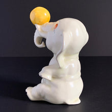 Load image into Gallery viewer, RARE FIND!!!
Adorable art deco white circus elephant balancing yellow ball porcelain figurine. Crafted by Crown Devon, England, 1920s/30s. Perfect for elephant collectors. Also makes a whimsical decor feature in a child's room.
In great vintage condition, no chips/cracks/repairs, minor paint loss. Marked Made in England.
Measures 4 x 5 1/2 inches