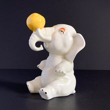 Load image into Gallery viewer, RARE FIND!!!
Adorable art deco white circus elephant balancing yellow ball porcelain figurine. Crafted by Crown Devon, England, 1920s/30s. Perfect for elephant collectors. Also makes a whimsical decor feature in a child's room.
In great vintage condition, no chips/cracks/repairs, minor paint loss. Marked Made in England.
Measures 4 x 5 1/2 inches