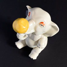 Load image into Gallery viewer, RARE FIND!!!
Adorable art deco white circus elephant balancing yellow ball porcelain figurine. Crafted by Crown Devon, England, 1920s/30s. Perfect for elephant collectors. Also makes a whimsical decor feature in a child's room.
In great vintage condition, no chips/cracks/repairs, minor paint loss. Marked Made in England.
Measures 4 x 5 1/2 inches