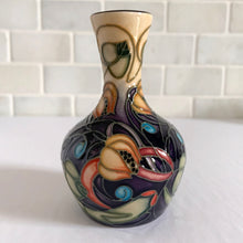 Load image into Gallery viewer, Lovely hand painted vintage "Celtic Web" bud vase designed by Emma Bossons in 2003. Shape 2/4. Hand painted florals on a yellow ground using the raised slip technique made famous by William Moorcroft. Produced by Moorcroft Pottery, Stoke-on-Trent, England. In excellent condition, no chips, cracks or repairs. First quality piece. Maker's marks present, see photos. Purchased from the Moorcroft Pottery shop and offered from our personal collection. Measures 4"
