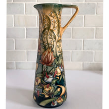 Load image into Gallery viewer, This beautiful "Prairie Summer" ewer pitcher or jug is reminiscent of a summer's day. Designed by Rachel Bishop in 2001 and hand painted over slip glaze on a yellow ground with shades of red, blue, yellow and white on shape JU3. Produced by Moorcroft Pottery, England. In excellent condition, no chips, cracks or repairs. In original box. Purchased directly from the Moorcroft Pottery shop in Stoke-on-Trent, England. Offer from our private collection. Measures 9-1/2"