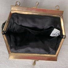 Load image into Gallery viewer, Stunning vintage art deco style beaded evening bag features black bugle and round glass beads in a fringe pattern, black silk lining, gold toned chain and kiss closure. Crafted by Artel, Hong Kong 1950s. Take your fashion to the next level with this elegant accessory.
In vintage condition, with a few beads missing.