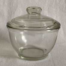 Load image into Gallery viewer, Vintage pressed glass lidded sugar bowl or apothecary jar. Crafted by Jeannette Glass, USA, 1950s. A versatile piece that could be used as a sugar bowl, bath or vanity storage.
In excellent condition, no chips. Marked on the bottom with a 'J' inside a square.
Measures 4 x 4 inches