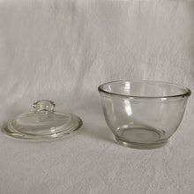 Load image into Gallery viewer, Vintage pressed glass lidded sugar bowl or apothecary jar. Crafted by Jeannette Glass, USA, 1950s. A versatile piece that could be used as a sugar bowl, bath or vanity storage.
In excellent condition, no chips. Marked on the bottom with a 'J' inside a square.
Measures 4 x 4 inches