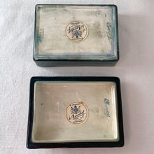 Load image into Gallery viewer, A lovely vintage "Columbine" dresser box with a jewel-toned flower against a green wash ground. Design by Walter Moorcroft and produced by Moorcroft Pottery, England, circa 1950. Stamped with the WM Moorcroft signature and "Made in England" along with paper label having the Royal Warrant and "By Appointment, Potter to the late Queen Mary". In excellent condition, free from chips, cracks, repairs; crazing present. Measures 4.75" x 3.5" x 2"