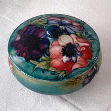 Load image into Gallery viewer, Stunning vintage mid-century tube lined and hand painted "Anemone" lidded dish. Produced by Moorcroft Pottery, England, circa 1950s. A vibrant and gorgeous piece to depth to your decor. Measures 5-3/4" x 3-1/2" In excellent condition, free from chips/cracks/repairs. Normal crazing for a piece of this age.