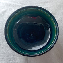Load image into Gallery viewer, Vintage mid-century "Clematis" lidded dish with green ground lid and teal/blue ground on bowl's interior and deep blue on the exterior of the bowl. The colours are vibrant and the tube lining and hand painting are spectacular. Produced by Moorcroft Pottery, England, circa 1950s.  Measures 6-1/4" x 3-1/2"  Excellent condition. No cracks or chips. Normal crazing for a piece of this age. Impressed marks include Walter Moorcroft's signature, Potter to H.M. The Queen and Made in England.