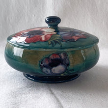 Load image into Gallery viewer, Stunning vintage mid-century tube lined and hand painted "Anemone" lidded dish. Produced by Moorcroft Pottery, England, circa 1950s. A vibrant and gorgeous piece to depth to your decor. Measures 5-3/4" x 3-1/2" In excellent condition, free from chips/cracks/repairs. Normal crazing for a piece of this age.