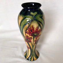 Load image into Gallery viewer, Vintage hand painted Ragged Poppy limited edition art pottery vase, number 113/350. Designed by Nicole Slaney in 2003. This piece is hand painted over slip glaze with a deep blue ground in shades of yellow, green and red on shape 75/10. Produced by Moorcroft Pottery, Stoke-on-Trent England. Excellent condition, no chips, cracks or repairs. First quality. Maker's marks, edition and signed by the artist on the bottom, see photos. Measures 4-1/2" x 11"