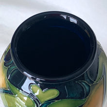 Load image into Gallery viewer, Vintage hand painted Ragged Poppy limited edition art pottery vase, number 113/350. Designed by Nicole Slaney in 2003. This piece is hand painted over slip glaze with a deep blue ground in shades of yellow, green and red on shape 75/10. Produced by Moorcroft Pottery, Stoke-on-Trent England. Excellent condition, no chips, cracks or repairs. First quality. Maker's marks, edition and signed by the artist on the bottom, see photos. Measures 4-1/2" x 11"