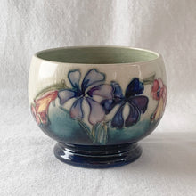 Load image into Gallery viewer, The sweetest pattern of "Spring Flowers" adorns this open sugar bowl. Hand crafted by Moorcroft Pottery, England, circa 1950s. In excellent condition, free from chips/cracks/repairs, with normal crazing for a piece of this age. Impressed with Walter Moorcroft's signature, "H.M. Potter To The Queen" and "Made in England" Measures 3 3/4 x 2 3/4 inches
