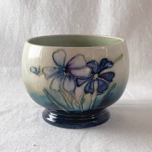 Load image into Gallery viewer, The sweetest pattern of "Spring Flowers" adorns this open sugar bowl. Hand crafted by Moorcroft Pottery, England, circa 1950s. In excellent condition, free from chips/cracks/repairs, with normal crazing for a piece of this age. Impressed with Walter Moorcroft's signature, "H.M. Potter To The Queen" and "Made in England" Measures 3 3/4 x 2 3/4 inches