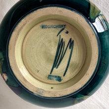 Load image into Gallery viewer, Gorgeous vintage mid-century hand painted squat flower vase in the "Orchid" pattern on green ground, hand painted in shades of red, yellow, purple and blue using the slip glaze technique. Made by Moorcroft Pottery in Stoke-on-Trent, England, circa 1950. In excellent condition, no chips, cracks or repairs, crazing present. Initials of Walter Moorcroft in blue, impressed marks "MOORCROFT" and "MADE IN ENGLAND". Measures 3-1/4" high