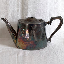 Load image into Gallery viewer, Vintage Victorian style silver plated teapot, creamer and sugar etched with bow and ribbon details and great patina. Ideal for mad hatters tea party, vintage decor or props. Would be perfect for a 'shabby chic' decor scheme or repurposed for a floral arrangement, or redesign as your imagination allows.
Teapot is missing lid finial.
In as found condition.