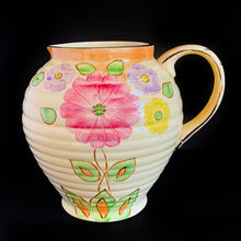 Load image into Gallery viewer, Vintage Art Deco horizontal ribbed beehive handled pitcher, No. 1881E, featuring hand painted florals in shades of pink, purple, green, yellow and orange on a butter yellow ground with gold gilt details. Crafted by Kensington Ware, England, 1940s. A lovely piece to add to your tableware and home decor!
In excellent vintage condition, no chips/cracks/repairs, typical age-related crazing. Maker's marks.
Measures 7 1/2 x 8 1/2 x 8 inches