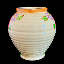 Load image into Gallery viewer, Vintage Art Deco horizontal ribbed beehive handled pitcher, No. 1881E, featuring hand painted florals in shades of pink, purple, green, yellow and orange on a butter yellow ground with gold gilt details. Crafted by Kensington Ware, England, 1940s. A lovely piece to add to your tableware and home decor!
In excellent vintage condition, no chips/cracks/repairs, typical age-related crazing. Maker's marks.
Measures 7 1/2 x 8 1/2 x 8 inches