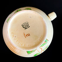 Load image into Gallery viewer, Vintage Art Deco horizontal ribbed beehive handled pitcher, No. 1881E, featuring hand painted florals in shades of pink, purple, green, yellow and orange on a butter yellow ground with gold gilt details. Crafted by Kensington Ware, England, 1940s. A lovely piece to add to your tableware and home decor!
In excellent vintage condition, no chips/cracks/repairs, typical age-related crazing. Maker's marks.
Measures 7 1/2 x 8 1/2 x 8 inches