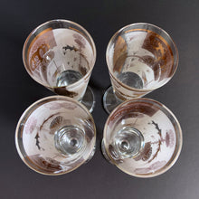 Load image into Gallery viewer, Set of four vintage mid-century Golden Meadow clear pilsner or champagne glasses featuring a delightful design of butterflies, thistles and botanicals in 22kt gold against a frosted band on Federal Glass blanks. Designed by Fred Press, USA, 1960s. These hard to find glasses will be a luxurious addition to any barware collection!
In excellent condition, no chips. Minor wear commensurate with age.
Measures 8 1/2 inches tall
Capacity 8 ounces