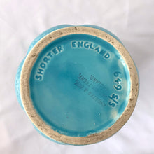 Load image into Gallery viewer, A lovely vintage art deco sky blue and white speckled feminine fluted vase with leaf handles. Crafted by Shorter & Son, England, 1940s. A beautiful vase to use as a decor piece or fill it with a beautiful bouquet of flowers!
In good vintage condition, two flea bites on the rim which aren't too noticeable thanks to the white speckled glaze. No cracks or repairs. Maker's marks.
Measures 5 x 8 3/4 inches