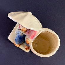Load image into Gallery viewer, Vintage Chinoiserie style highly detailed ceramic planter featuring an Asian gentleman with umbrella alongside a basket shades of beige, blue and red. Crafted by Shawnee Pottery, USA, 1940s. Perfect for a succulent.
In excellent condition, no chips/cracks.
Measures 5 x 3 1/4 x 5 1/4 inches