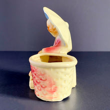Load image into Gallery viewer, Vintage Chinoiserie style highly detailed ceramic planter featuring an Asian gentleman with umbrella alongside a basket shades of beige, blue and red. Crafted by Shawnee Pottery, USA, 1940s. Perfect for a succulent.
In excellent condition, no chips/cracks.
Measures 5 x 3 1/4 x 5 1/4 inches